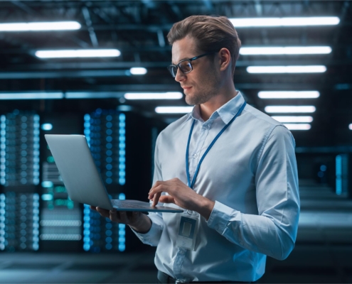 Person looking at computer in data center
