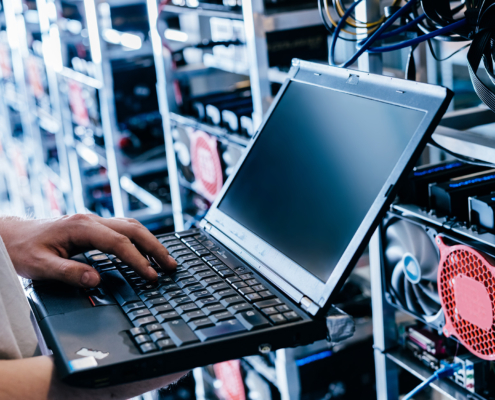 IT specialist working on computer in server room